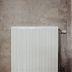 white metal panel heater on gray concrete wall